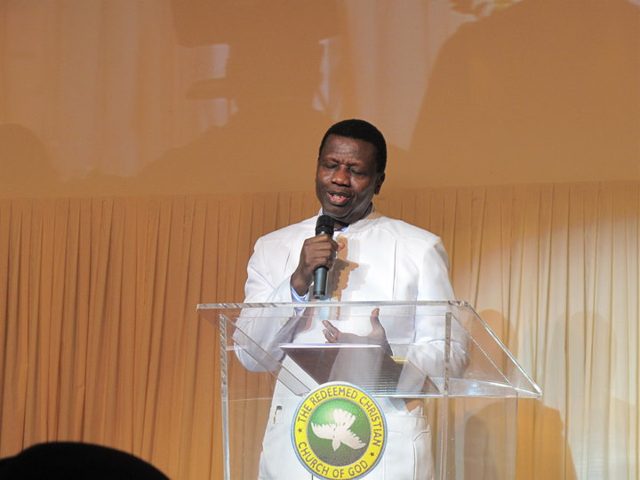 Pastor Enoch Adeboye preaching at a lectern