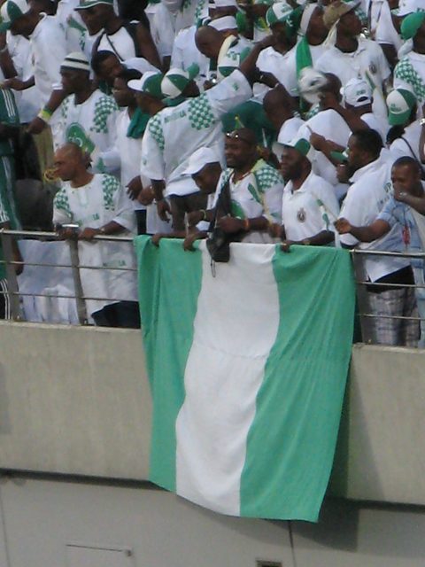 Nigeria supporters in green and white hold up the national flag (stock image)