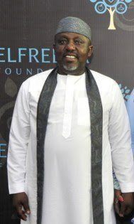 Rochas Okorocha in a white kaftan and cap