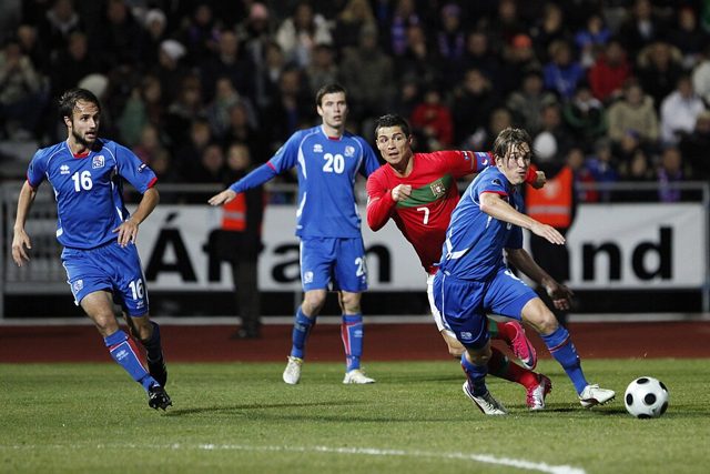 Cristiano Ronaldo, in red, playing for Portugal
