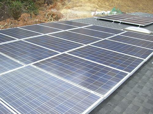 Rows of solar panels on a roof (stock image)