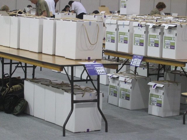 Ballot boxes lined up on tables (stock image)