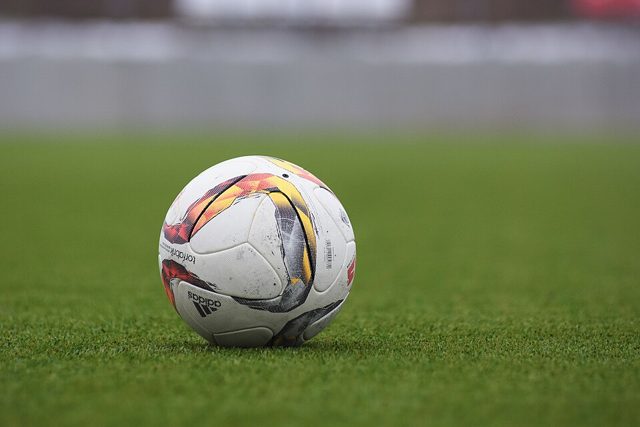 A football on a grass pitch